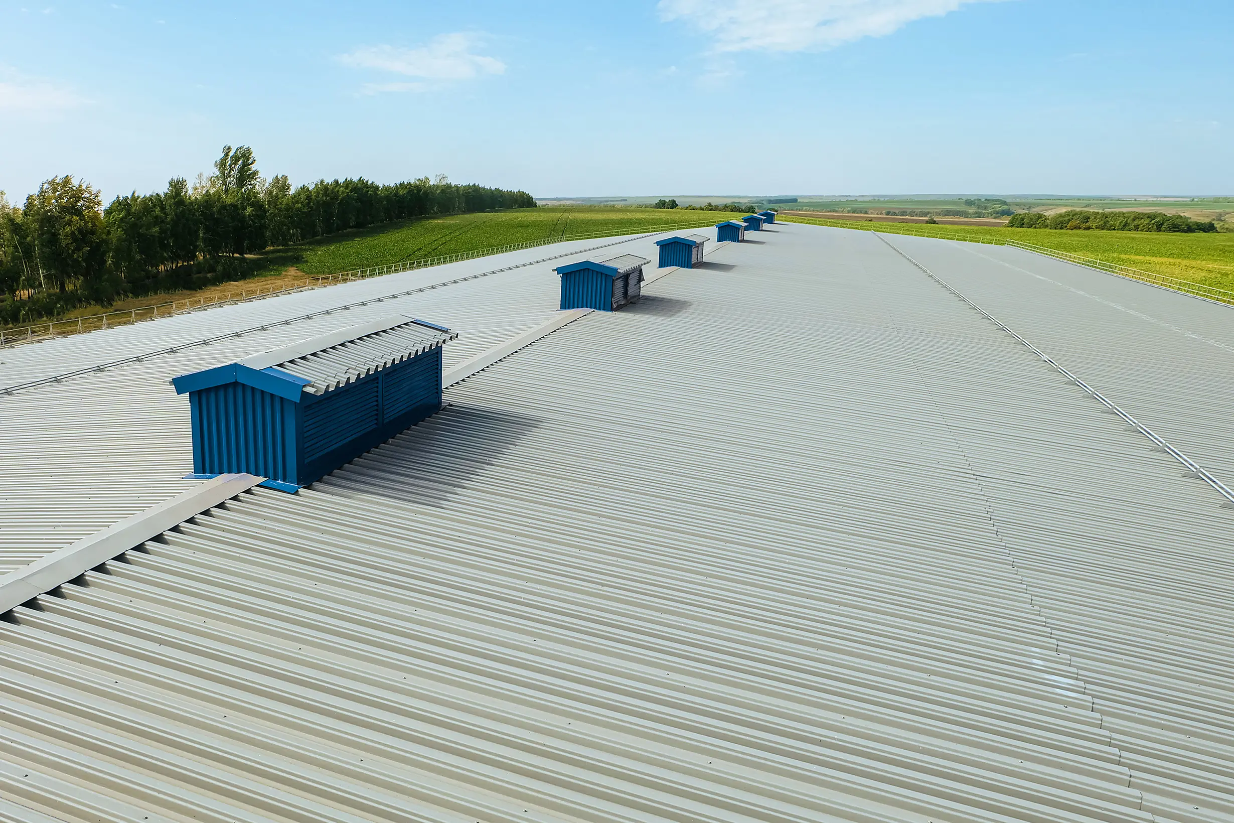 Industrial rooftops with blue ventilation structures.