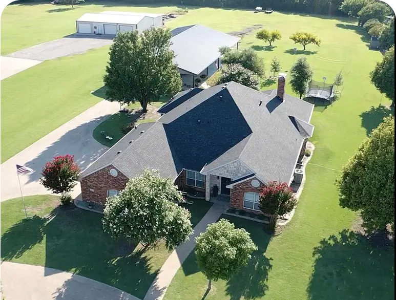 Aerial view of house with green lawn.