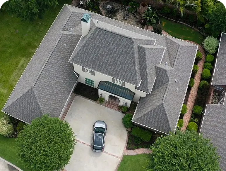 Aerial view of house with car parked.